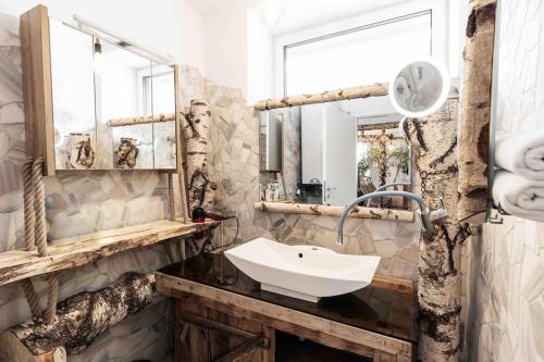 a bathroom with a sink and a mirror at Birken Suite in Ramsau