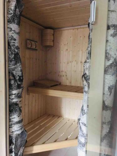 a small wooden sauna with a wooden shelf in it at Birken Suite in Ramsau