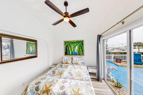 a bedroom with a bed and a ceiling fan at Dolphin Court #9 in St Pete Beach