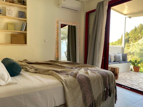 a bedroom with a bed with a large mirror at Cozy 2-bdrm-house with garden and view, Katouna Home III in Katouna