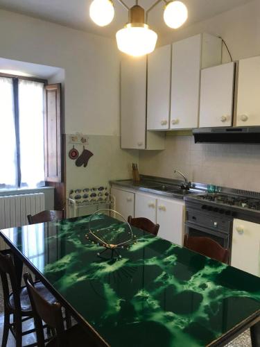 a kitchen with a table with a green counter top at Villa Margherita in Grotte