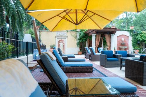 a group of chairs and umbrellas on a patio at Hotel Granduca Houston in Houston