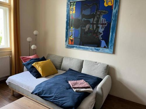 a couch with pillows on it in a living room at Mama's apartment in Letna in Prague