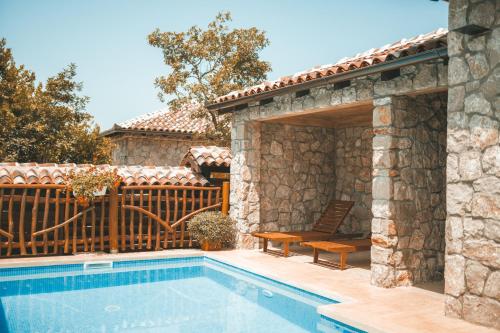 a house with a swimming pool and a patio at Resort & Villas Carević in Budva