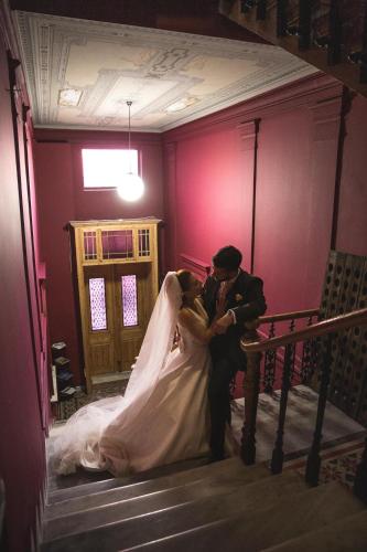 a bride and groom kissing on the stairs of a church at VASILIKON Hotel 1888 the past is present HISTORICAL PRESERVATION MONUMENT in Kalamata