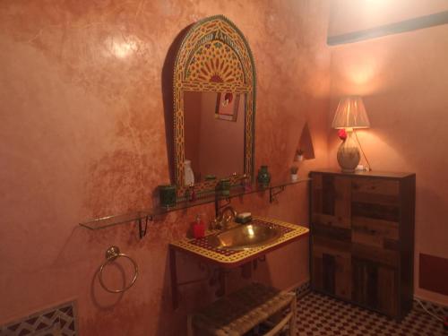 ein Bad mit einem Waschbecken und einem Spiegel in der Unterkunft Riad El Badii in Marrakesch