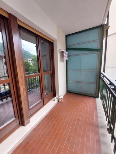 a balcony with a blue garage door and windows at La petite rose in Limone Piemonte