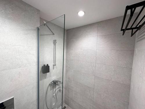 a shower with a glass door in a bathroom at SuprStay - Belgrade Waterfront Luxury Apartment in Belgrade
