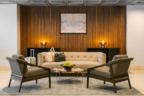 a living room with a couch and two chairs at Sonder The Quincy in Washington, D.C.