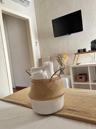 a basket of towels sitting on top of a bed at Apulia Journey - Manzoni 11 in Bari