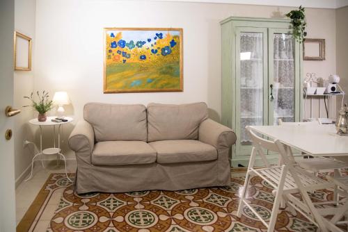 a living room with a couch and a table at Dimora del Castellano CASA SATURNO in Gioia del Colle