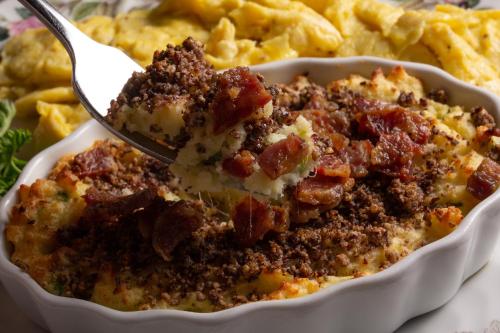 a spoon in a dish of food with potato chips at Rosemont Inn in Utica