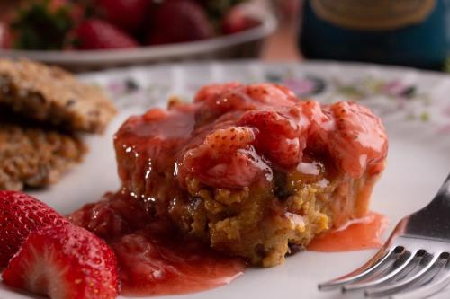 a piece of strawberry cake on a plate with a fork at Rosemont Inn in Utica