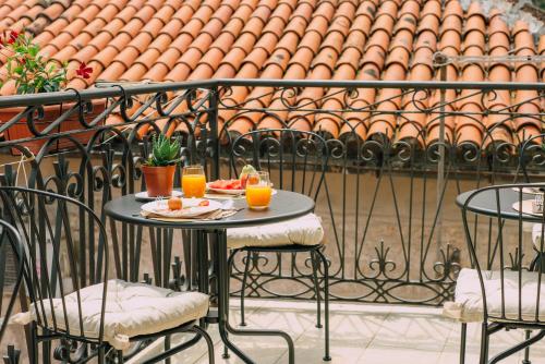 a table with food and orange juice on a balcony at Filip Deluxe Rooms in Kotor