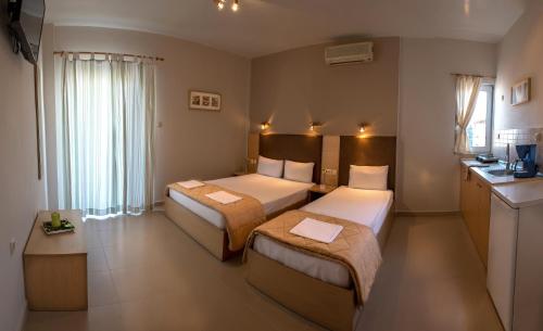 A bed or beds in a room at Nepheli Apartments and Studios