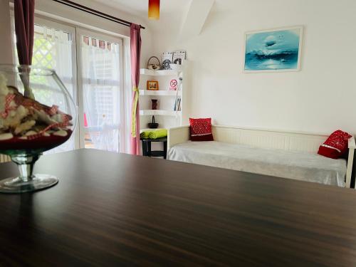 a room with a table with a wine glass on it at Apartament Raluca - self check-in in Timişoara