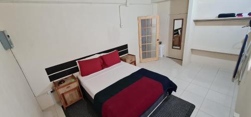 a bedroom with a bed with a red and black blanket at Carolina Point Resort in Crown Point