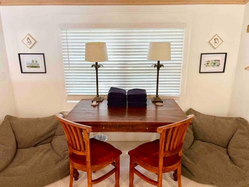 a dining room table with two lamps and a couch at Liz Lane Cottage- entire guesthouse in Charleston