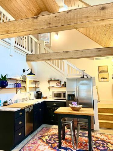 a kitchen with a sink and a table in it at Liz Lane Cottage- entire guesthouse in Charleston
