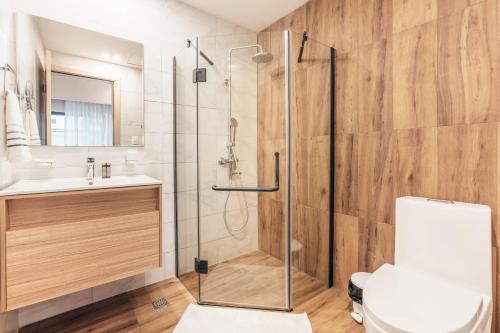 a bathroom with a shower and a toilet and a sink at Fully Serviced Apartment at Regatta Living II - 302 in La Julia