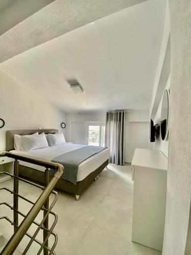 a bedroom with a bed and a staircase in a room at INTERNI LUXURY LIVING in Nikiti