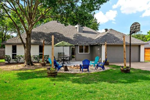 a house with blue chairs in the yard at Remodeled 4 Bedroom Home Close to Downtown Frisco. in Frisco