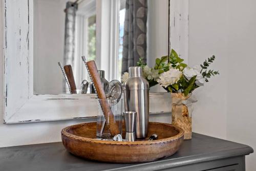 a wooden bowl on a counter with a sink and a mirror at Remodeled 4 Bedroom Home Close to Downtown Frisco. in Frisco