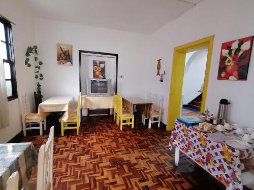 a living room with a table and a dining room at Galapagos Natural Life Hostel in Quito