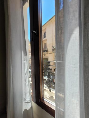 a window with a view of a balcony at La Casa Alandí con garaje privado in Sagunto