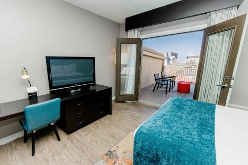 a hotel room with a bed and a flat screen tv at Hotel Indigo San Antonio Riverwalk by IHG in San Antonio