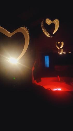 a room with a bed and a heart shaped light at L'antico vicolo in Nunziata