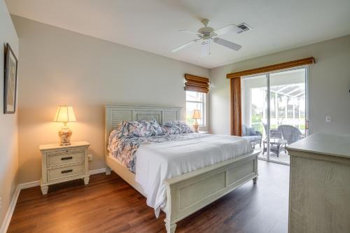 Schlafzimmer mit einem Bett, einem Tisch und einem Fenster in der Unterkunft Sunny Fort Myers Home with Heated Pool! in Fort Myers