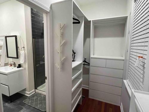 a bathroom with a walk in shower and a sink at Cozy Chicago Apartment next to the River in Chicago