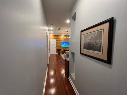 a hallway with white walls and a picture on a wall at Cozy Chicago Apartment next to the River in Chicago