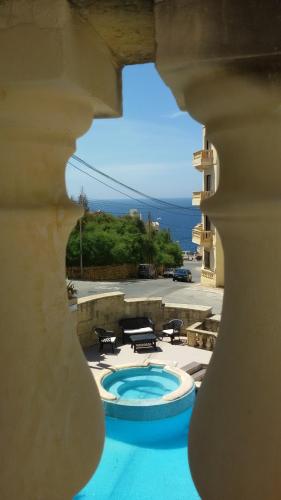 a view of a swimming pool from a building at Villa Xemxija in Xlendi