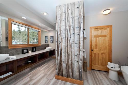 a bathroom with two sinks and a wooden door at 1601 Lake Purgatory Drive in Durango