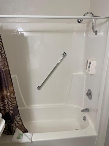 a bathroom with a white tub and a shower at Americas Best Value Inn Polson in Polson