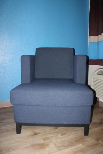 a blue couch in a room with a blue wall at Baymont Inn & Suites in Manning