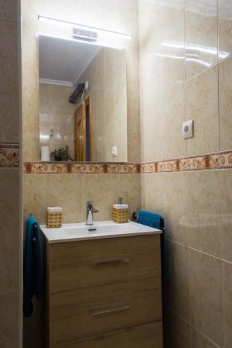 a bathroom with a sink and a mirror at Villa del Sol in Gran Alacant