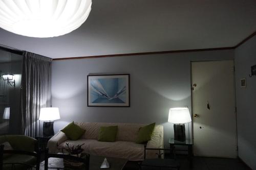 sala de estar con sofá y 2 lámparas en Departamento La Palmera, en Viña del Mar