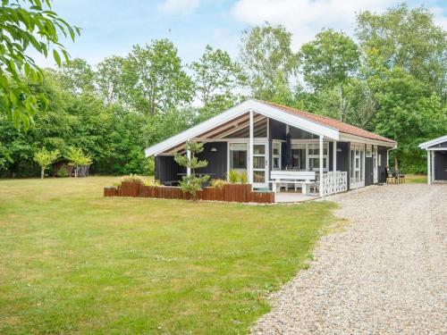 a black house with a large yard at 4 person holiday home in Oksbøl-By Traum in Oksbøl