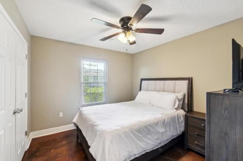a bedroom with a bed and a ceiling fan at Lovely Lake Charles Duplex in Central Location! in Lake Charles