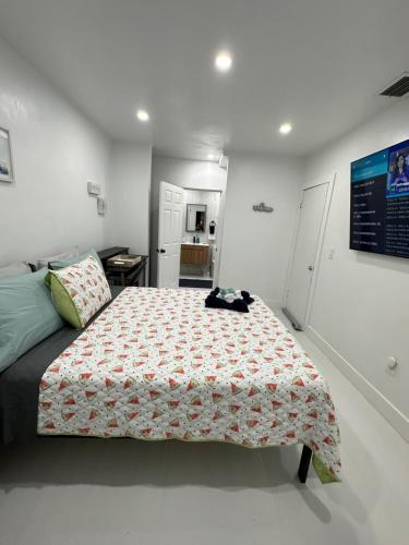 a bedroom with a bed with a flowered bedspread on it at Casa West Miami in Miami