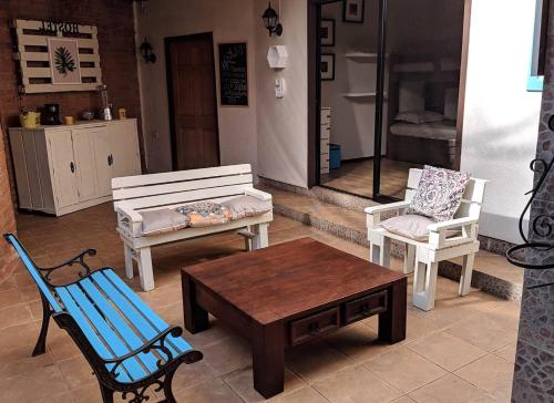 a patio with two chairs and a bench and a table at CASA PENSION PUERTA DEL SOL in Puerto Montt
