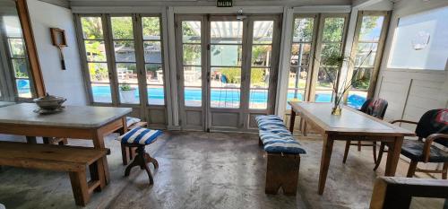 a room with tables and chairs and a swimming pool at Casa Tenis Hotel & Club in Benavídez