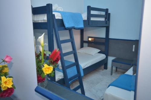 a bedroom with a bunk bed and a mirror at Hotel Elena Ermones in Ermones