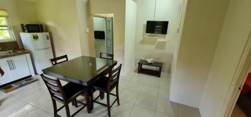 a kitchen with a table and chairs and a refrigerator at Carolina Point Resort in Crown Point