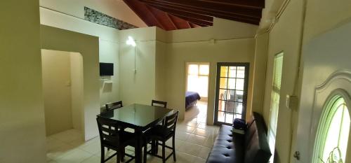 a dining room with a table and a bedroom at Carolina Point Resort in Crown Point
