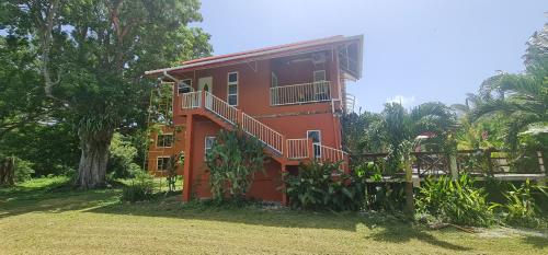 a red house with a yard in front of it at Carolina Point Resort in Crown Point