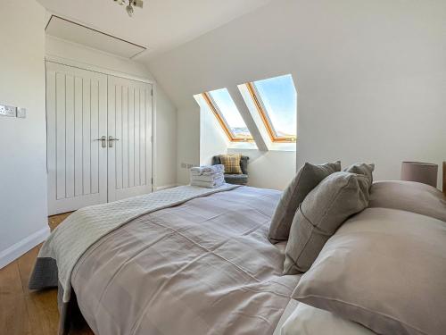 a large bed in a white room with skylights at Sealladh Apartment - Ukc6792 in Port Appin